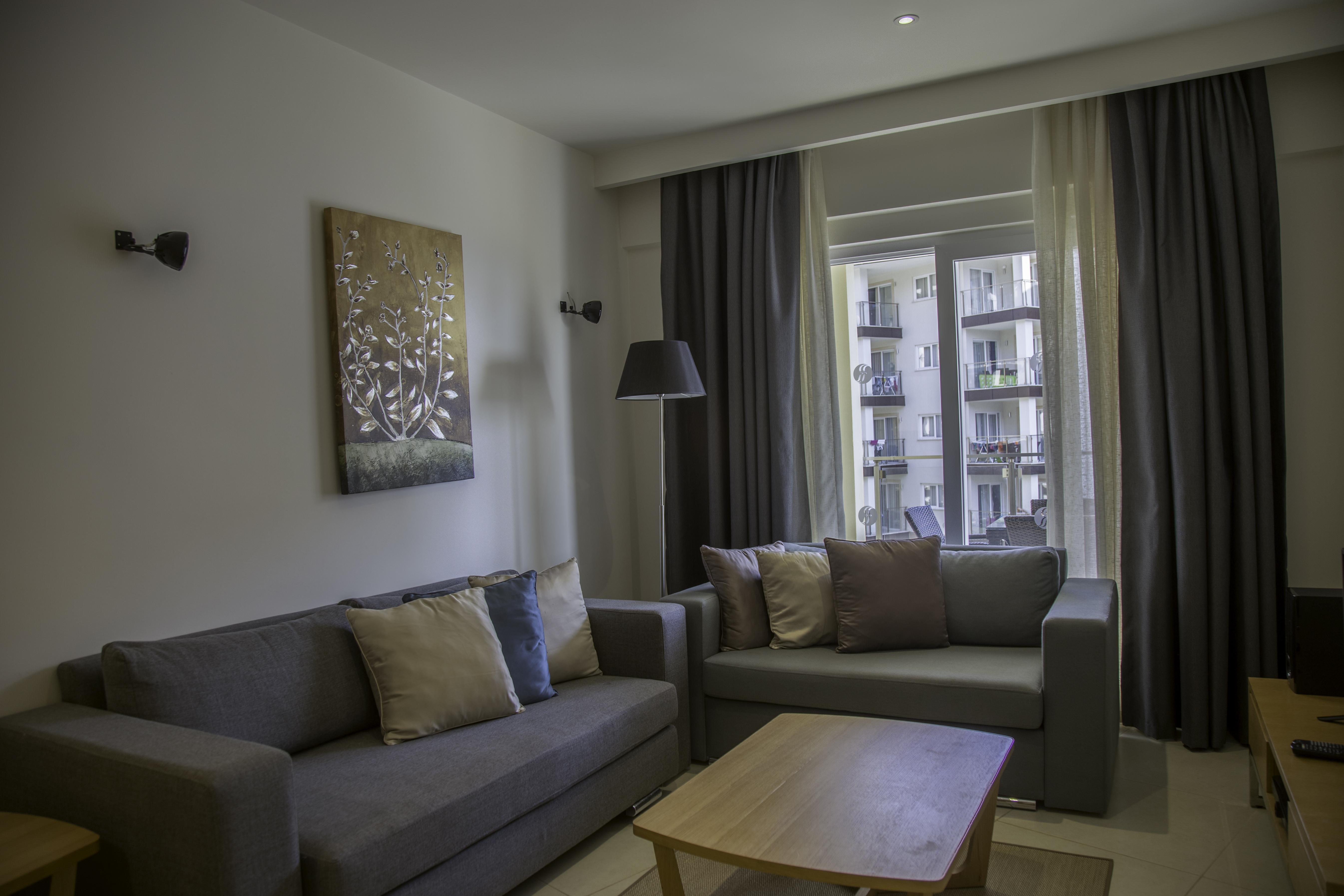 Ramada Resort Kusadasi & Golf Esterno foto A living room in a serviced apartment in Bucharest, Romania